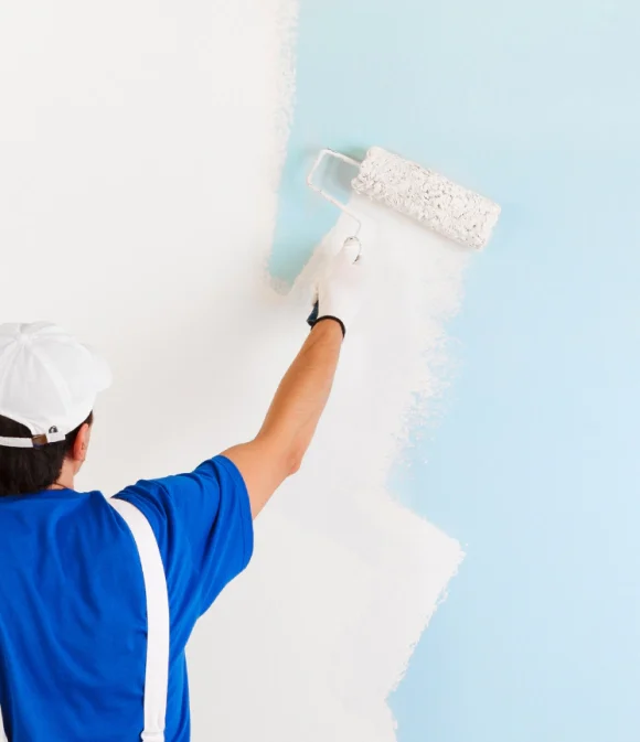 man painting a blue wall